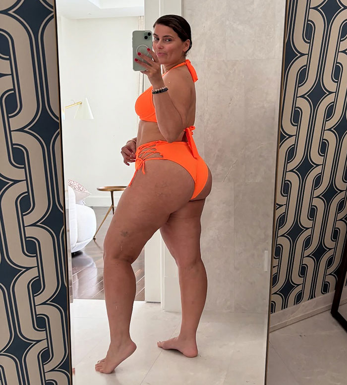 Nelly Furtado wearing a bright orange bikini without makeup
